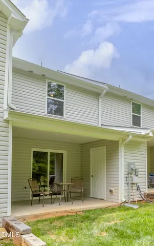 a front view of a house with a garden and plants