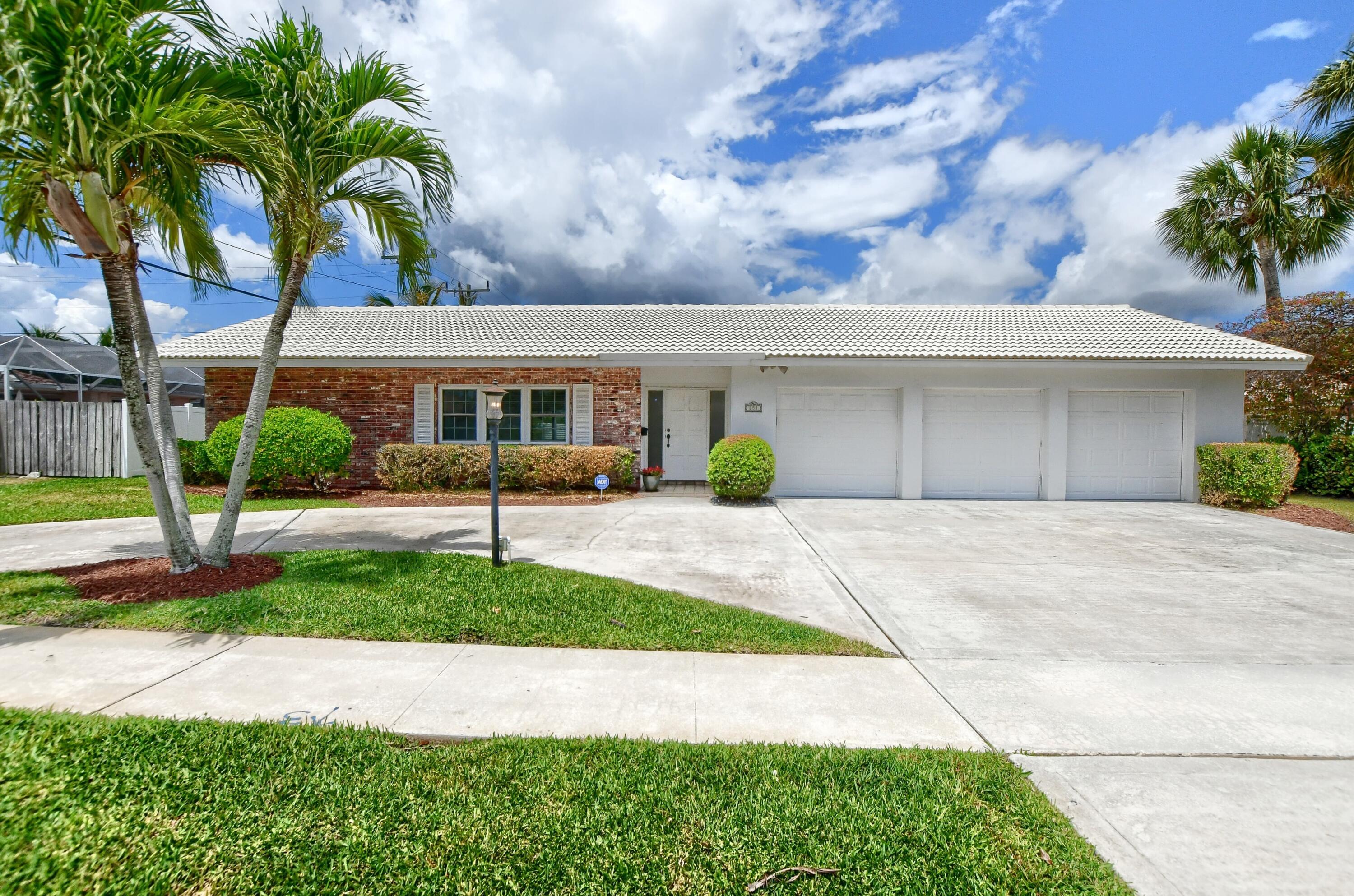 251 Southwest 9th Avenue Boca Raton, FL 33486 - Photo 1 of 37 a front view of a house with garden