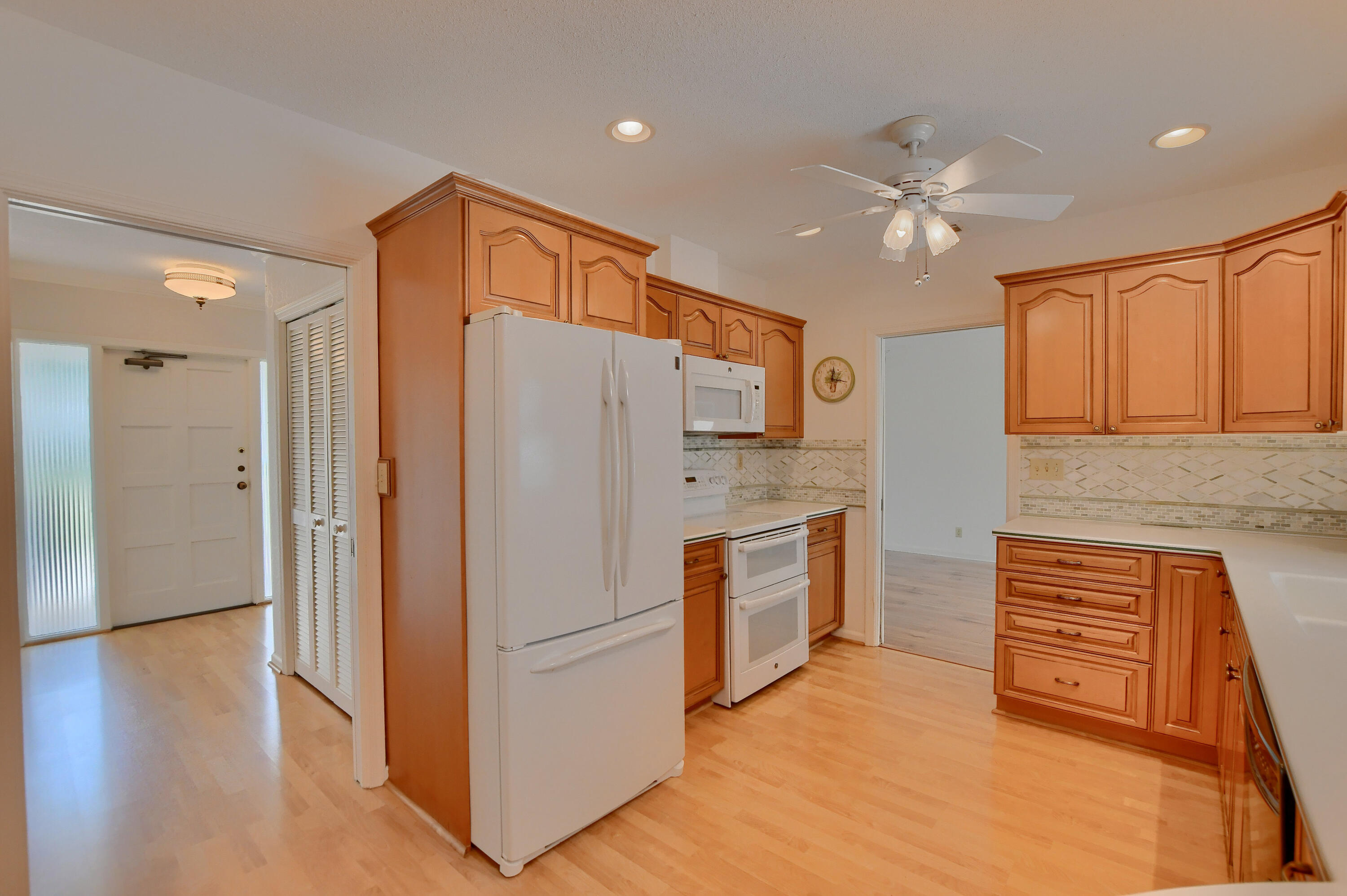 251 Southwest 9th Avenue Boca Raton, FL 33486 - Photo 12 of 37 a kitchen with stainless steel appliances a refrigerator and a stove top oven