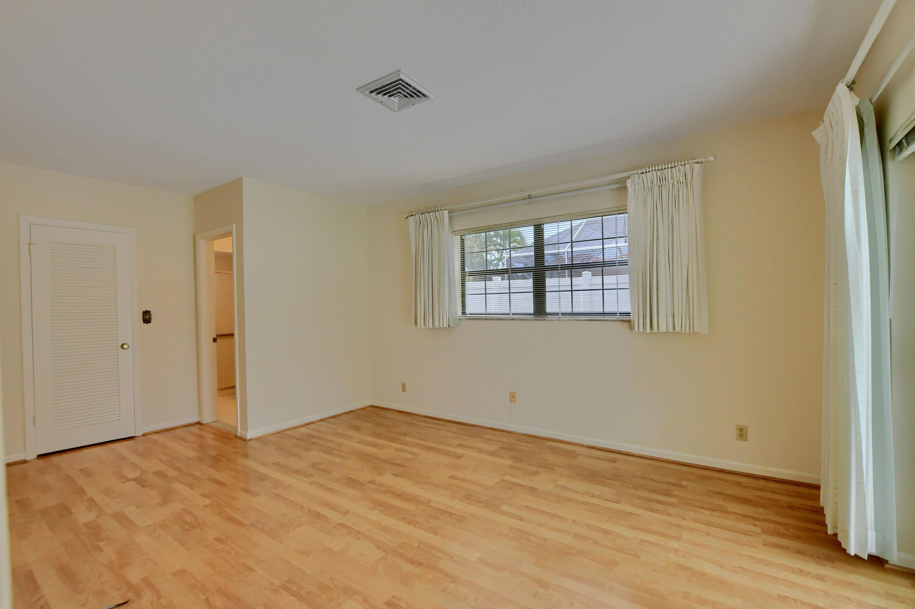 251 Southwest 9th Avenue Boca Raton, FL 33486 - Photo 15 of 37 a view of empty room with wooden floor and fan