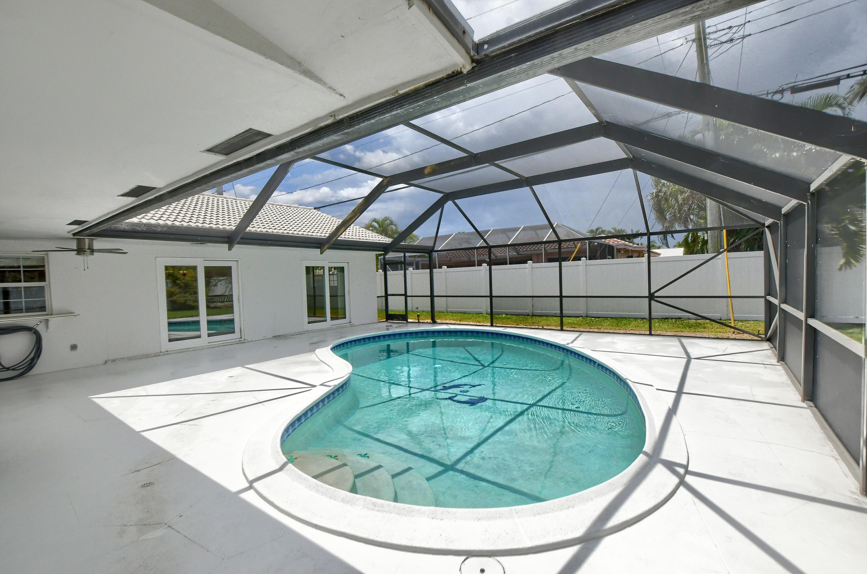 251 Southwest 9th Avenue Boca Raton, FL 33486 - Photo 27 of 37 a view of a swimming pool with a lounge chairs