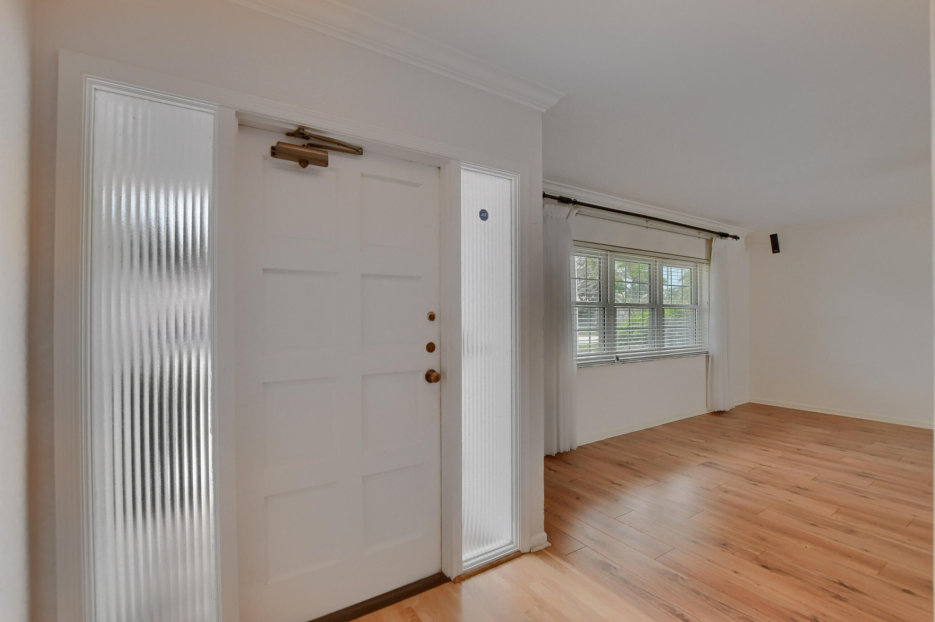 251 Southwest 9th Avenue Boca Raton, FL 33486 - Photo 3 of 37 a view of an empty room with wooden floor and a window