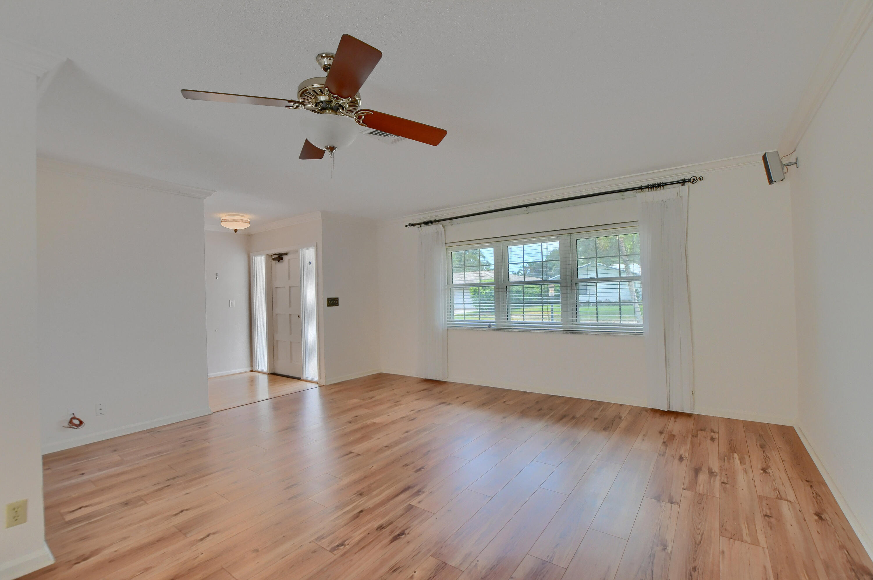 251 Southwest 9th Avenue Boca Raton, FL 33486 - Photo 6 of 37 an empty room with wooden floor fan and windows