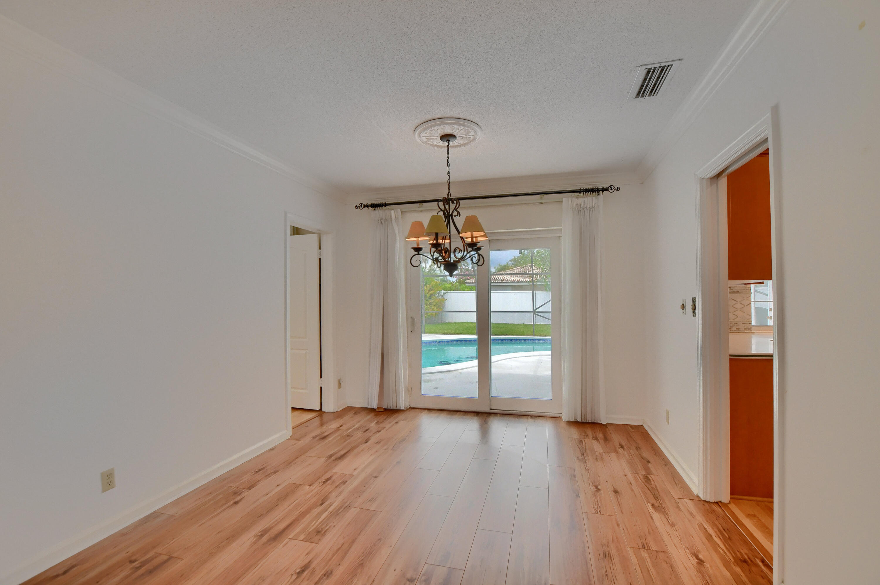 251 Southwest 9th Avenue Boca Raton, FL 33486 - Photo 7 of 37 a view of empty room with wooden floor and fan