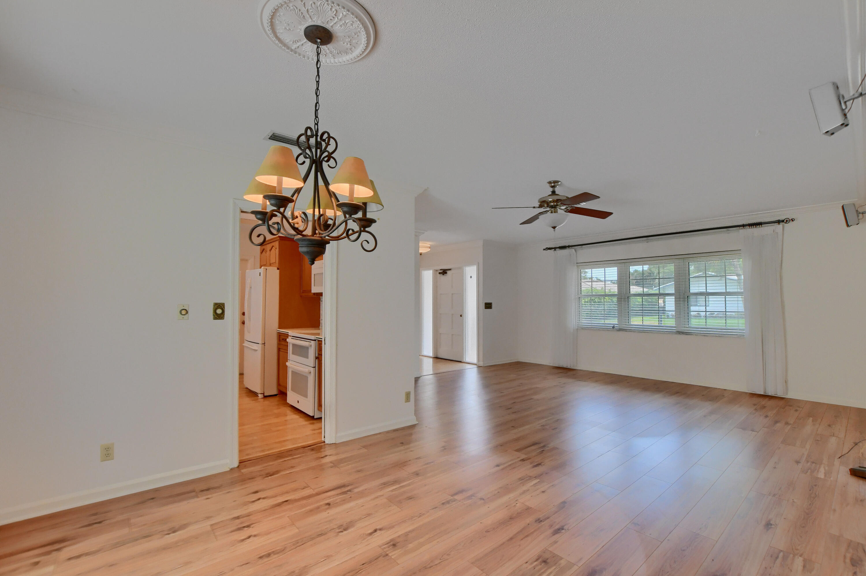 251 Southwest 9th Avenue Boca Raton, FL 33486 - Photo 8 of 37 a view of a room with wooden floor chandelier and a window