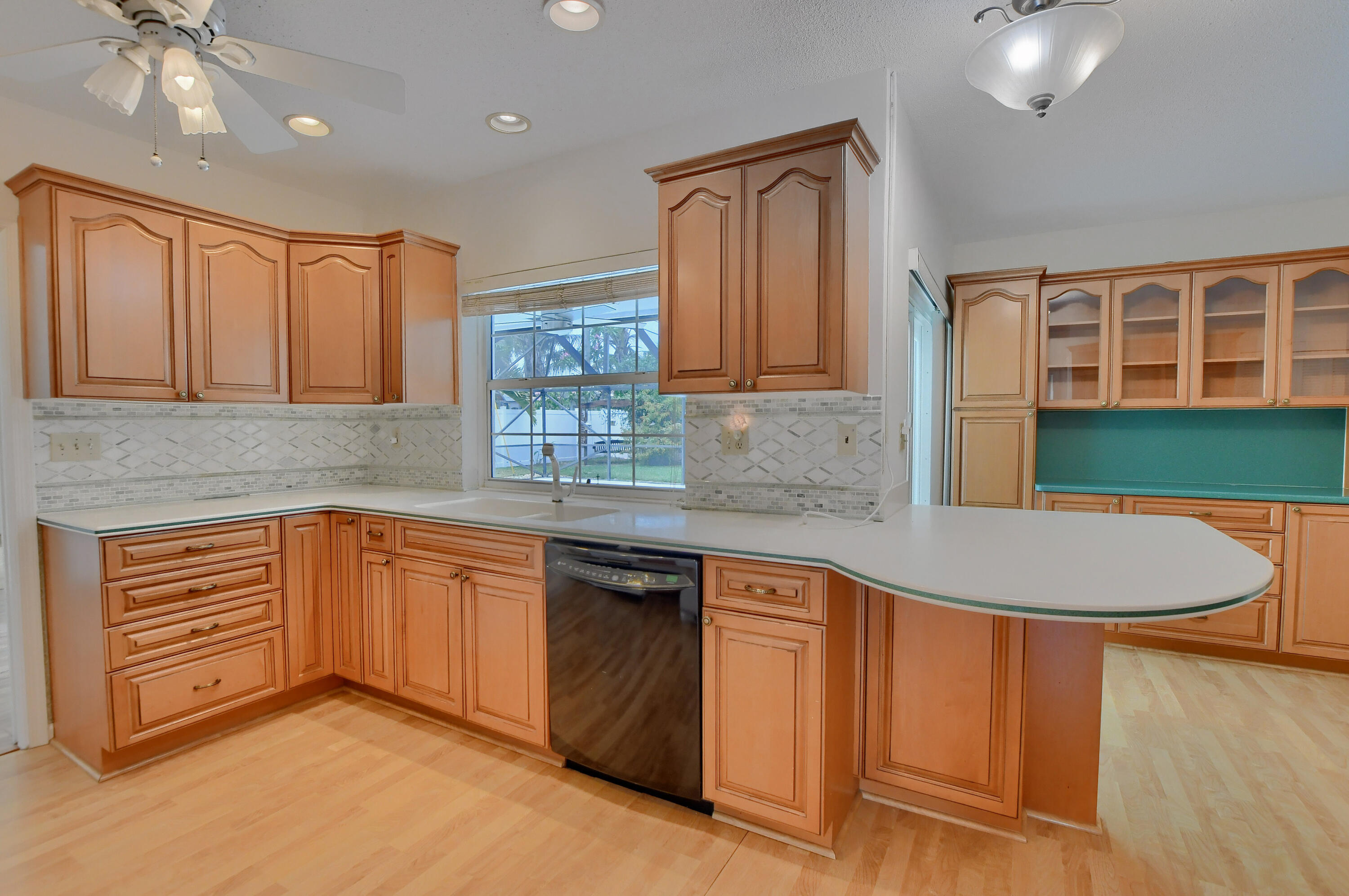 251 Southwest 9th Avenue Boca Raton, FL 33486 - Photo 9 of 37 a kitchen with stainless steel appliances granite countertop a sink and cabinets
