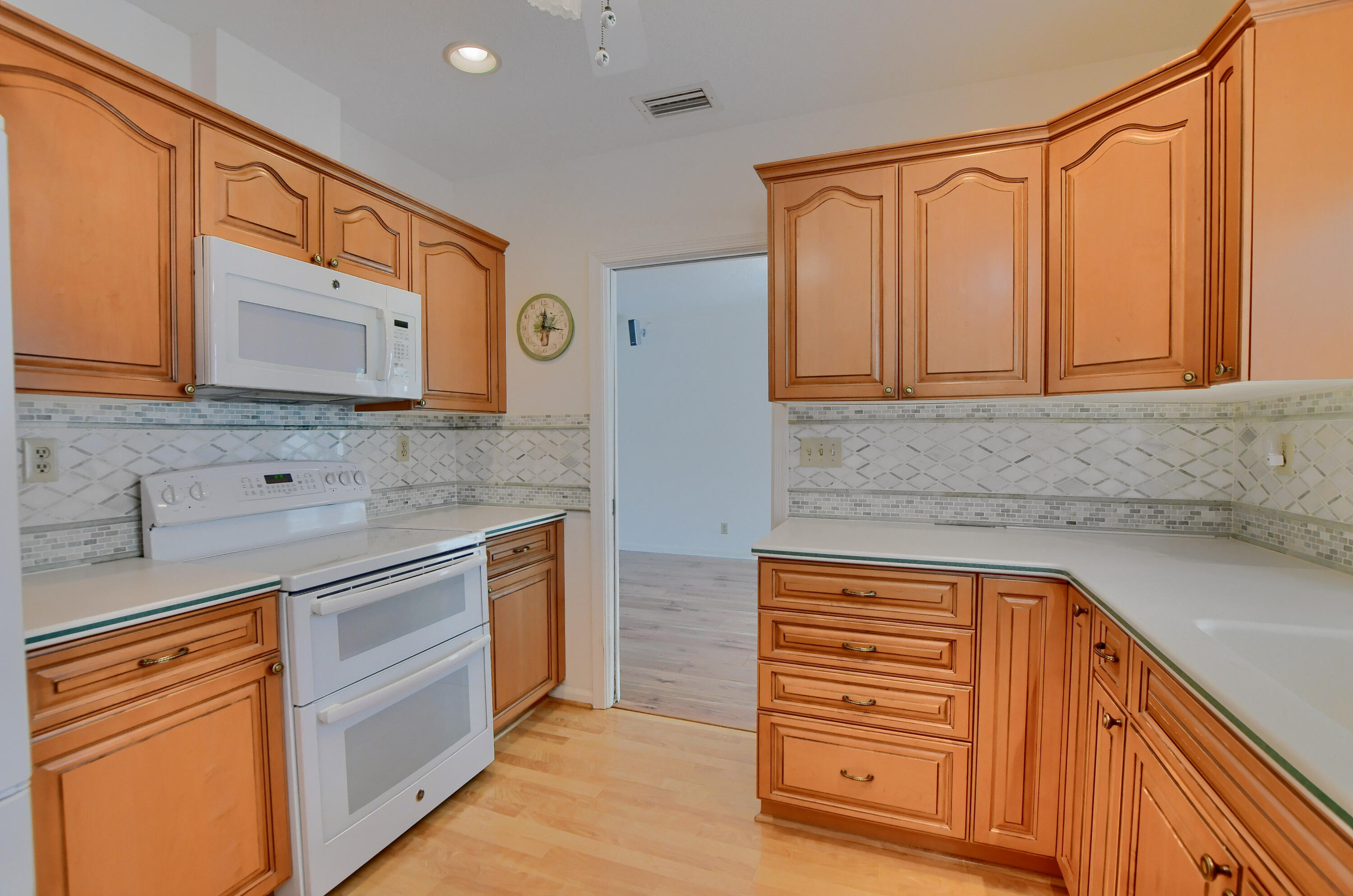 251 Southwest 9th Avenue Boca Raton, FL 33486 - Photo 10 of 37 a kitchen with stainless steel appliances granite countertop cabinets and a counter top space