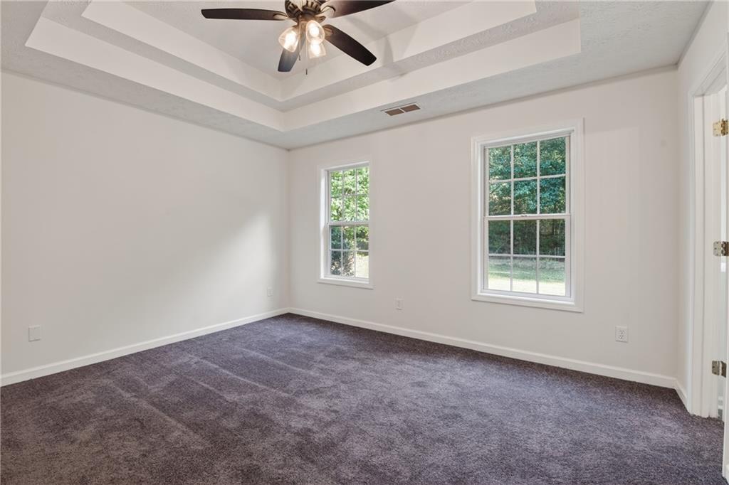 110 Chestnut Drive Covington, GA 30016 - Photo 12 of 27 an empty room with a window and a fan