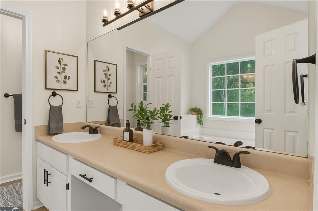 110 Chestnut Drive Covington, GA 30016 - Photo 16 of 27 a bathroom with a granite countertop sink and a mirror