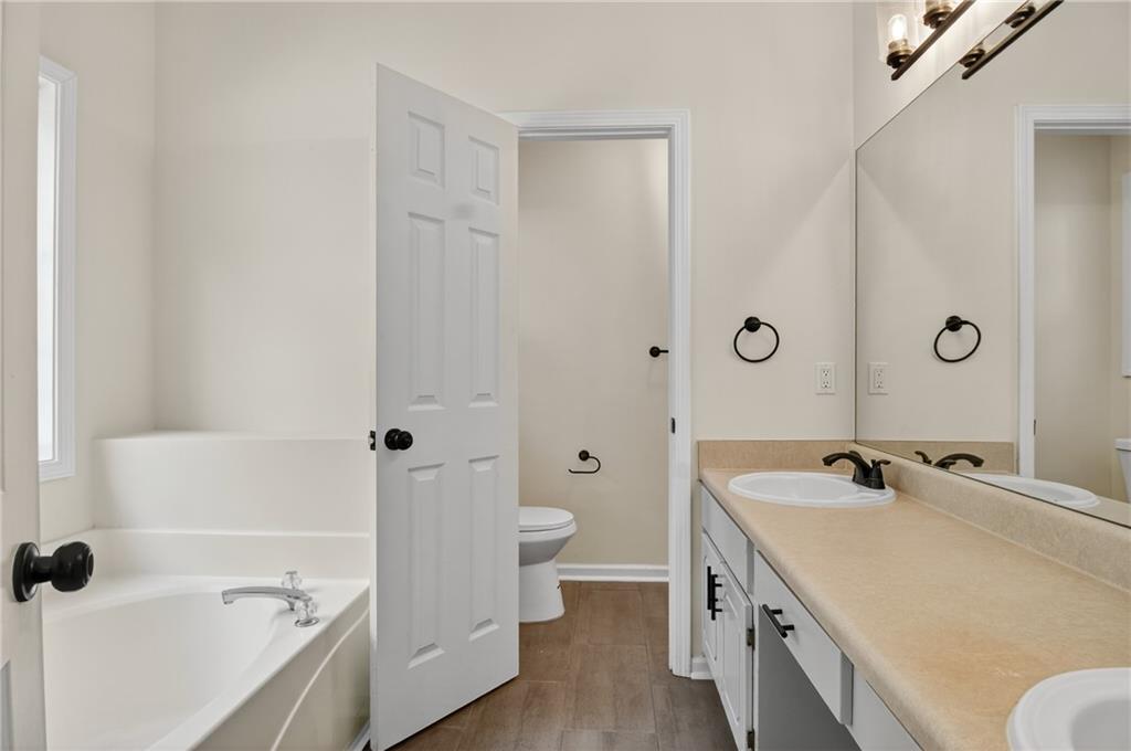 110 Chestnut Drive Covington, GA 30016 - Photo 18 of 27 a bathroom with a tub sink and toilet