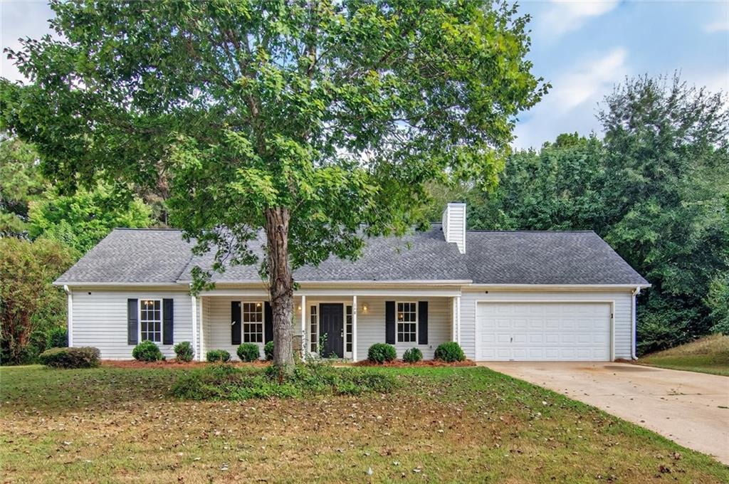 110 Chestnut Drive Covington, GA 30016 - Photo 2 of 27 a front view of a house with a garden