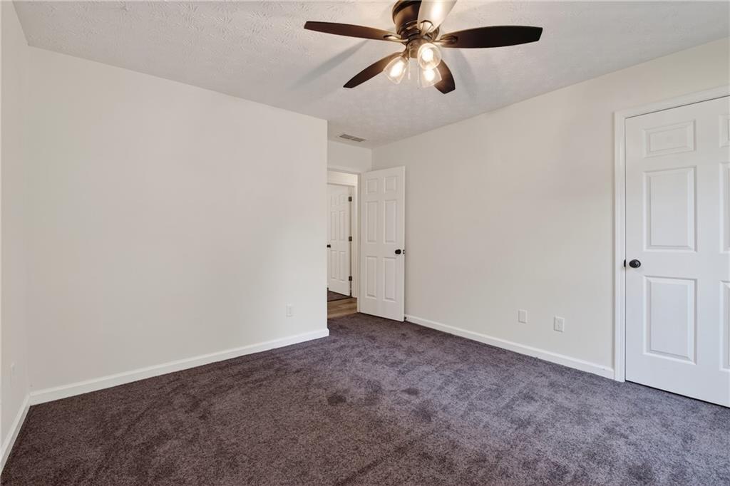 110 Chestnut Drive Covington, GA 30016 - Photo 23 of 27 an empty room with a window and a fan