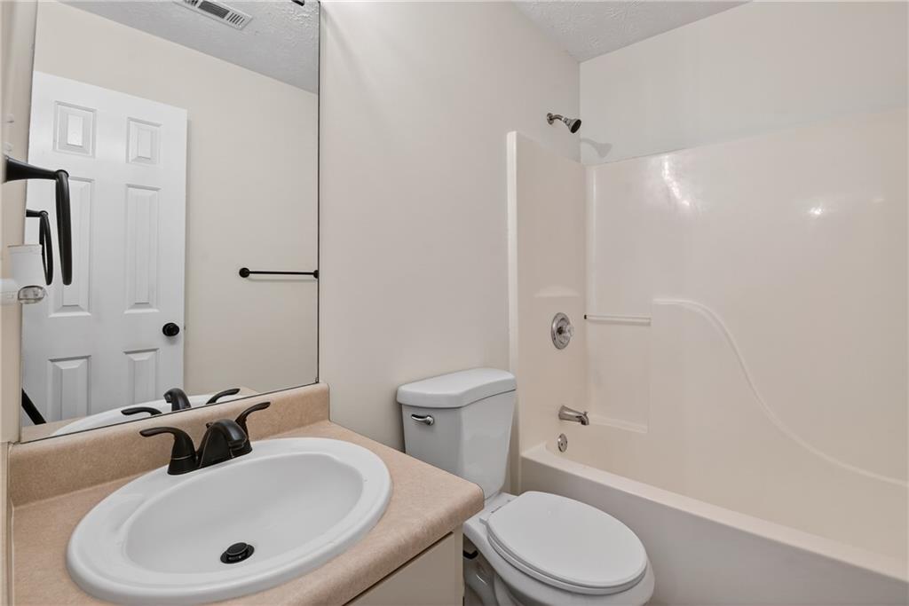 110 Chestnut Drive Covington, GA 30016 - Photo 25 of 27 a bathroom with a sink toilet and shower