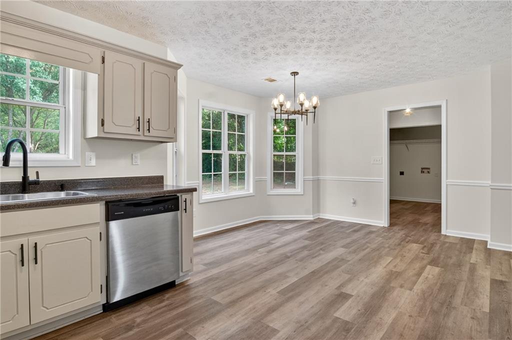 110 Chestnut Drive Covington, GA 30016 - Photo 6 of 27 an empty room with wooden floor and a sink