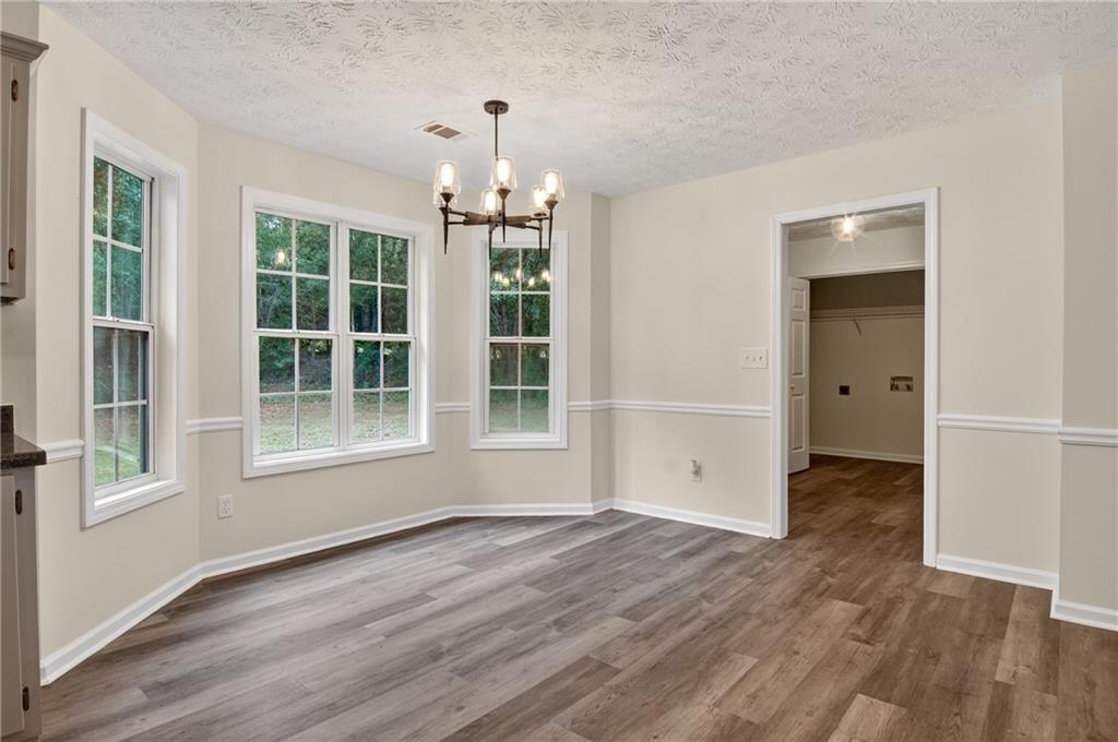 110 Chestnut Drive Covington, GA 30016 - Photo 8 of 27 wooden floor in an empty room with a window