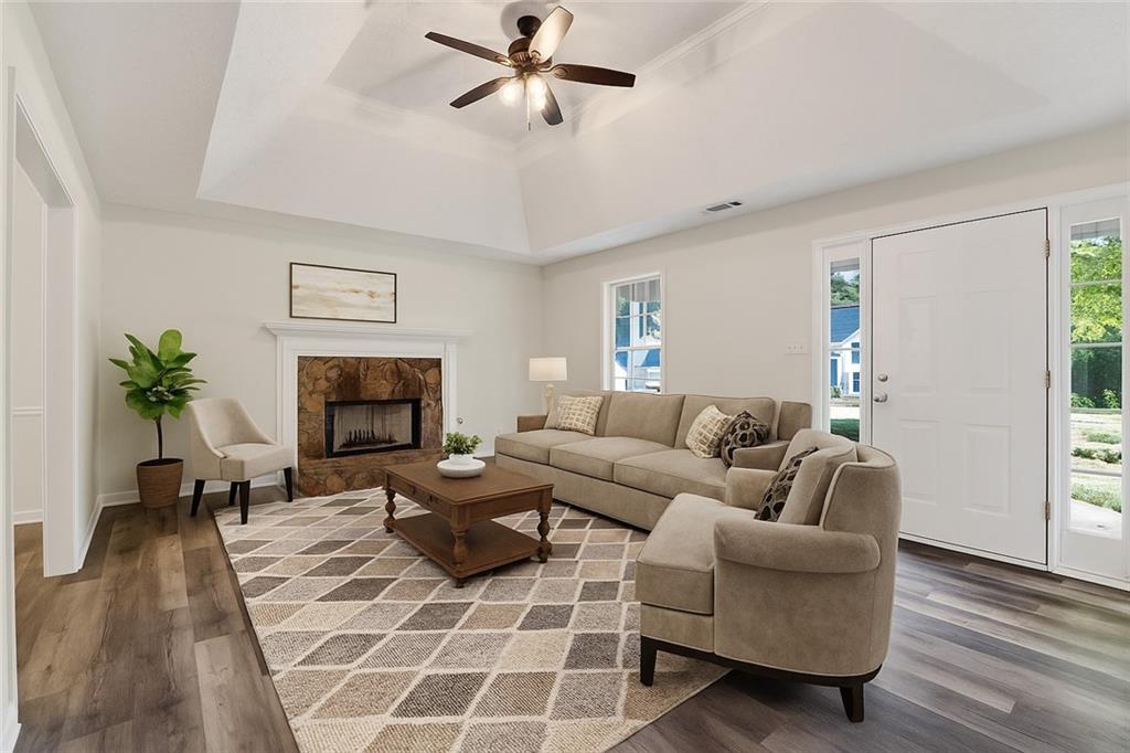 110 Chestnut Drive Covington, GA 30016 - Photo 9 of 27 a living room with furniture a fireplace and a potted plant