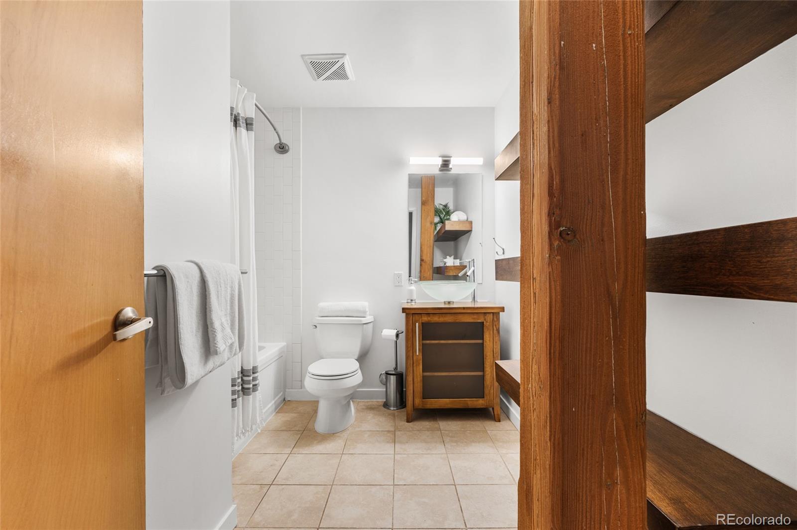 2501 Grove Street, Unit 101 Denver, CO 80211 - Photo 19 of 37 a bathroom with a toilet sink and tub
