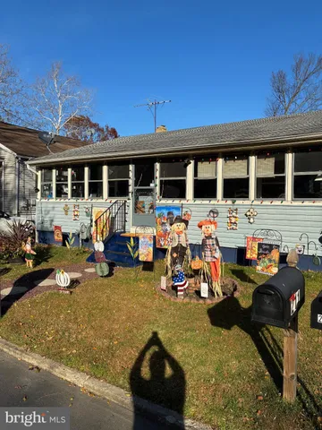 a front view of a house with cars parked