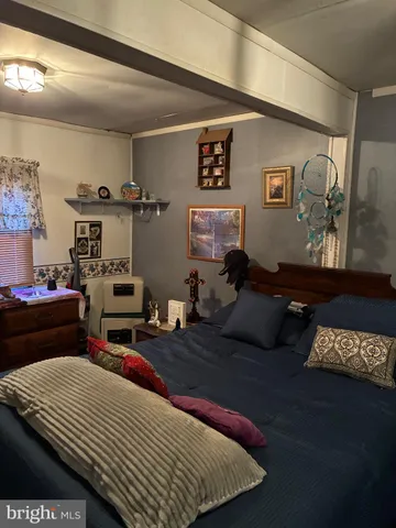 a bedroom with furniture and wooden floor
