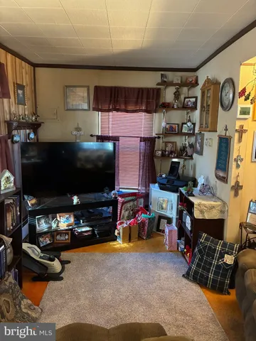 a room with gym equipment and a flat screen tv