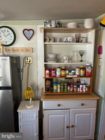 a kitchen with a refrigerator and a stove