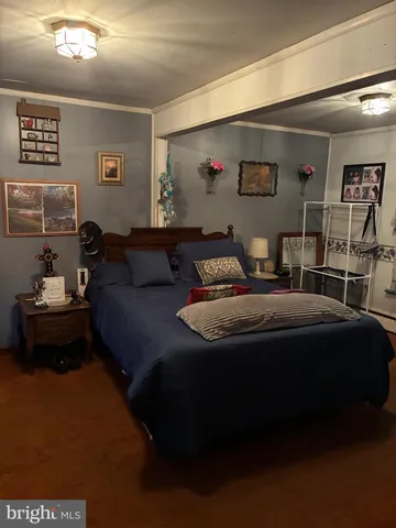 a bedroom with a bed and a wall painting