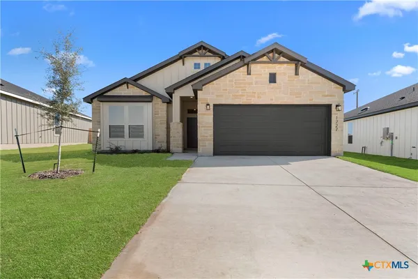 a front view of a house with a yard