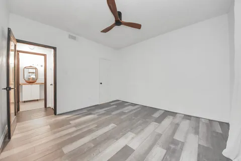a view of a kitchen with wooden floor and a refrigerator