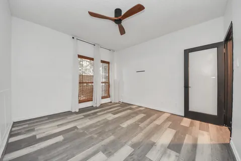 a kitchen with a sink and a stove top oven with wooden floor