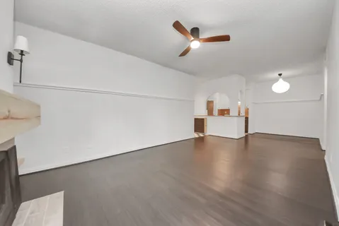 a view of empty room with ceiling fan