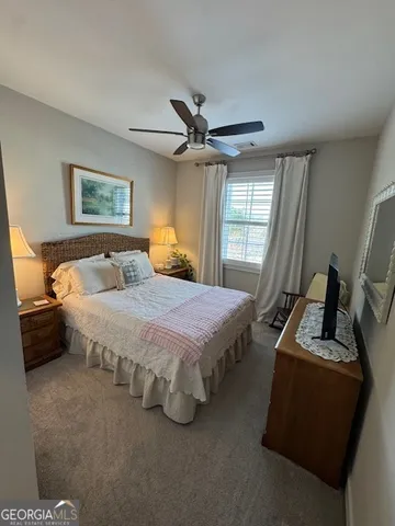 a spacious bedroom with a bed and a window