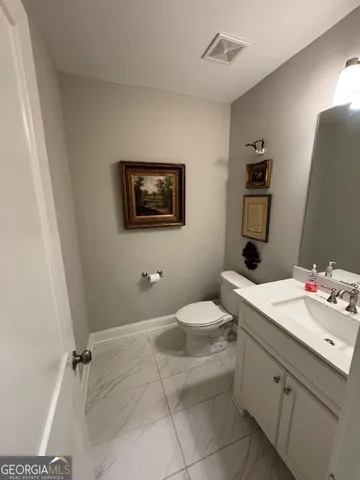 a view of a hallway with wooden floor and stairs