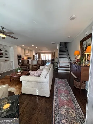 a living room with furniture and a piano
