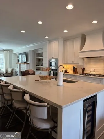 a kitchen with a sink a stove a refrigerator and cabinets