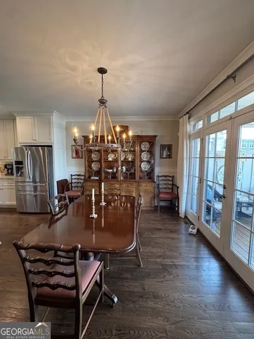 a dining room with furniture water view and wooden floor