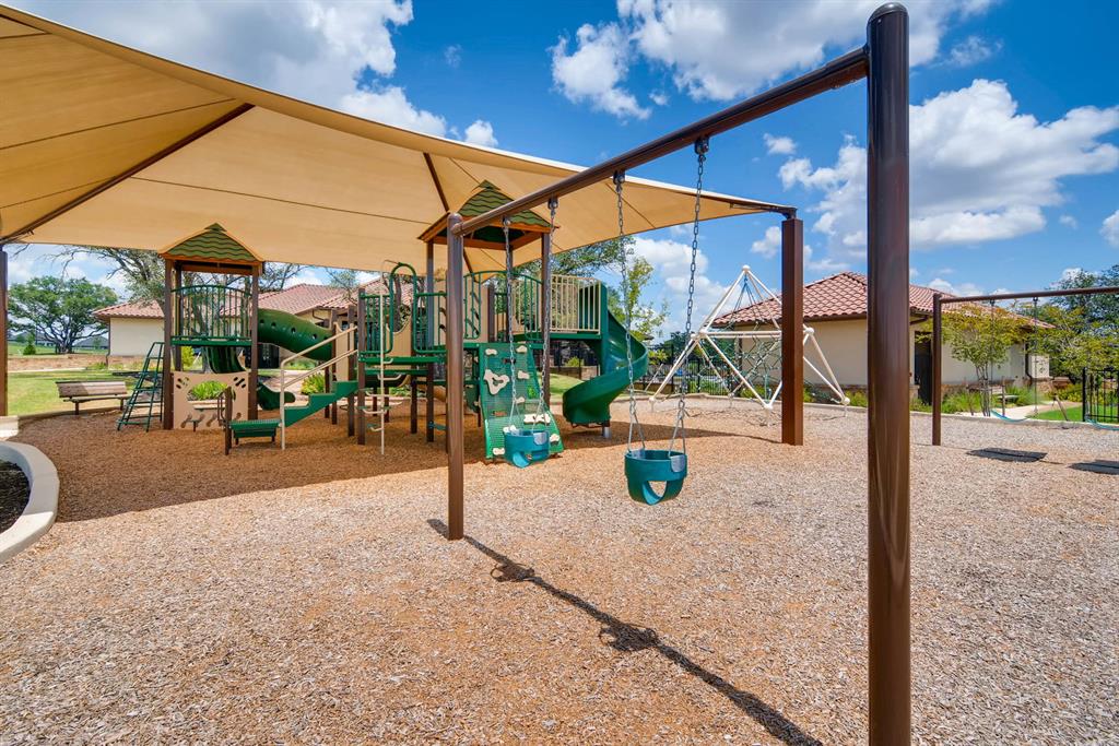 4201 Vespa Cove Leander, TX 78641 - Photo 29 of 29 a view of a patio with a table and chairs under an umbrella