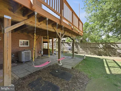 a view of a house with a yard patio and wooden fence