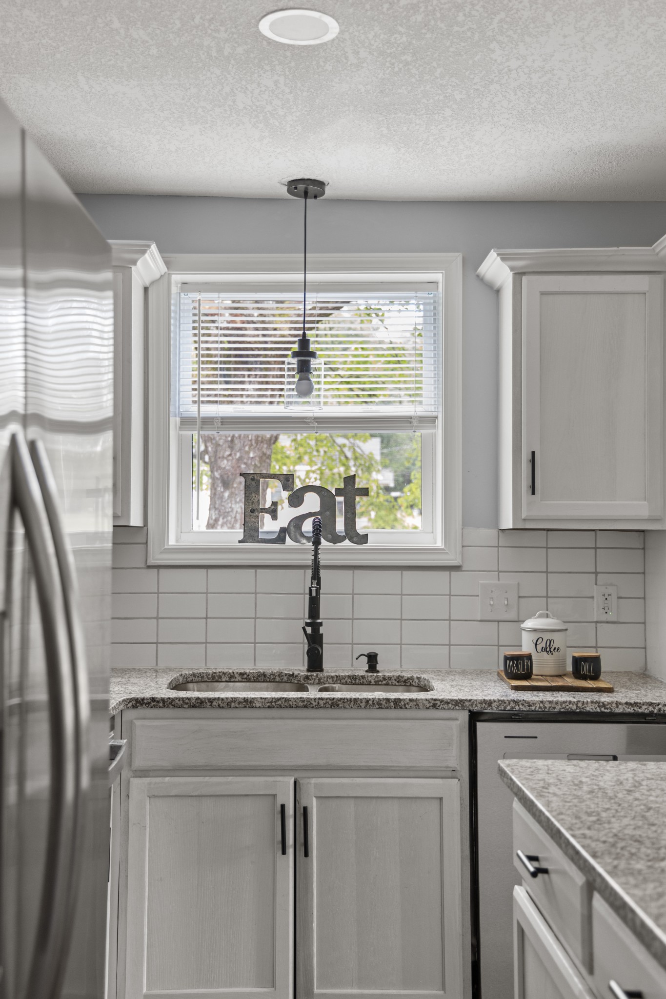 712 Westside Drive Tullahoma, TN 37388 - Photo 27 of 28 a kitchen with stainless steel appliances granite countertop a sink a window and cabinets