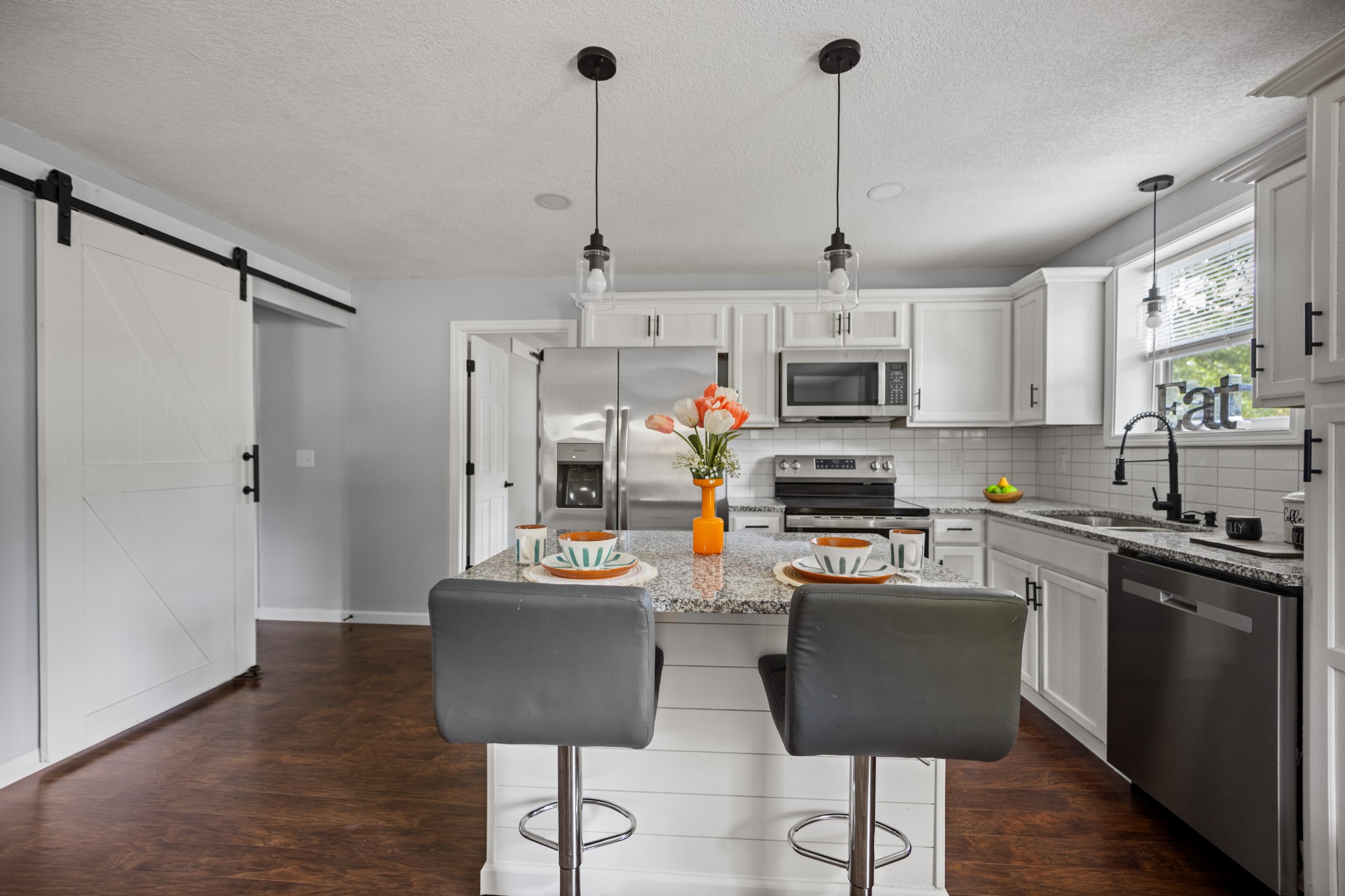 712 Westside Drive Tullahoma, TN 37388 - Photo 10 of 28 a kitchen with stainless steel appliances granite countertop a stove top oven a refrigerator a sink and dishwasher with wooden floor