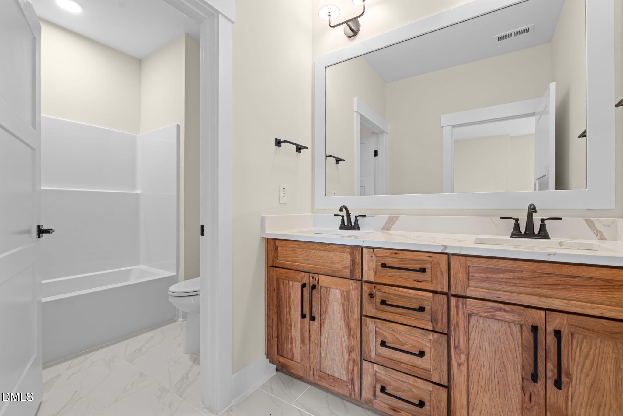 188 Landon Ridge Sanford, NC 27330 - Photo 19 of 44 a spacious bathroom with a double vanity sink a toilet and a bathtub