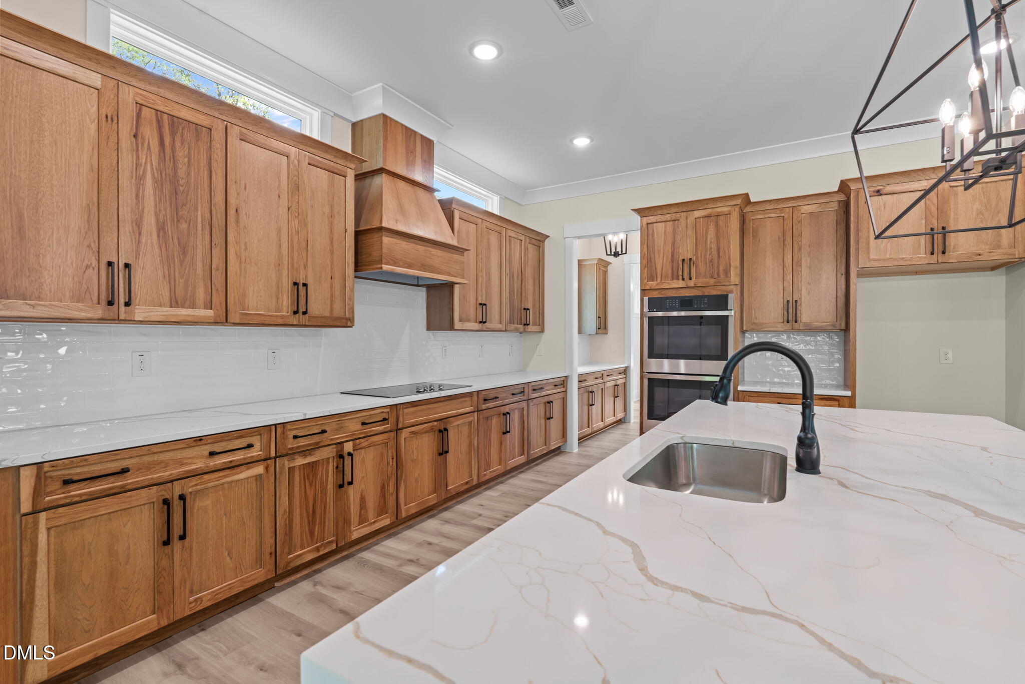 188 Landon Ridge Sanford, NC 27330 - Photo 3 of 44 a kitchen with stainless steel appliances granite countertop a sink a stove and cabinets