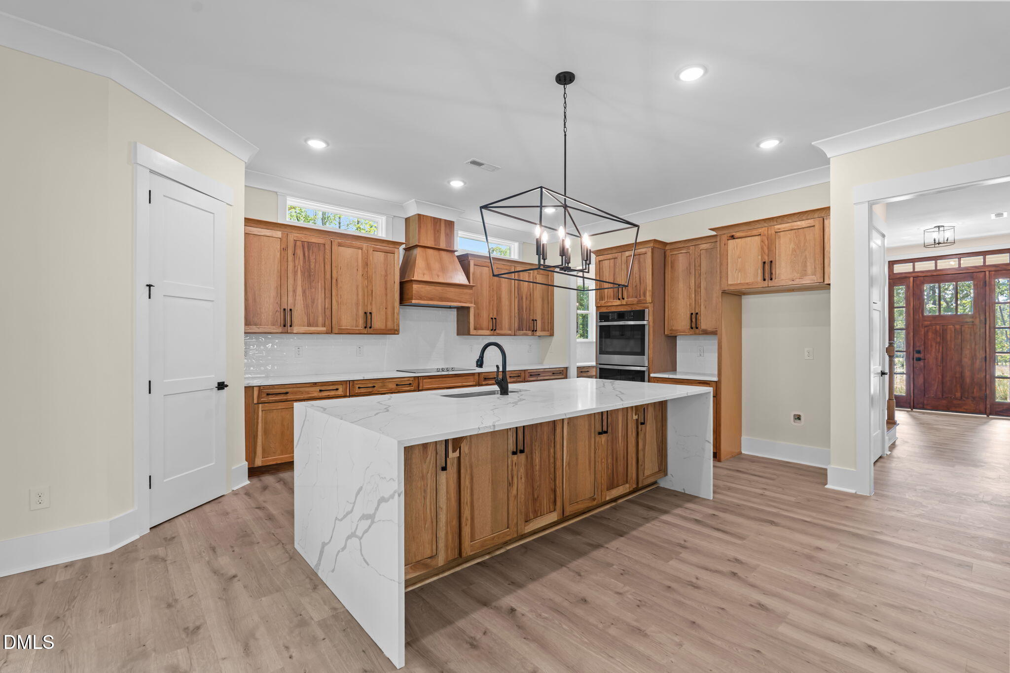188 Landon Ridge Sanford, NC 27330 - Photo 4 of 44 a large kitchen with stainless steel appliances a large counter top a sink a refrigerator and a window