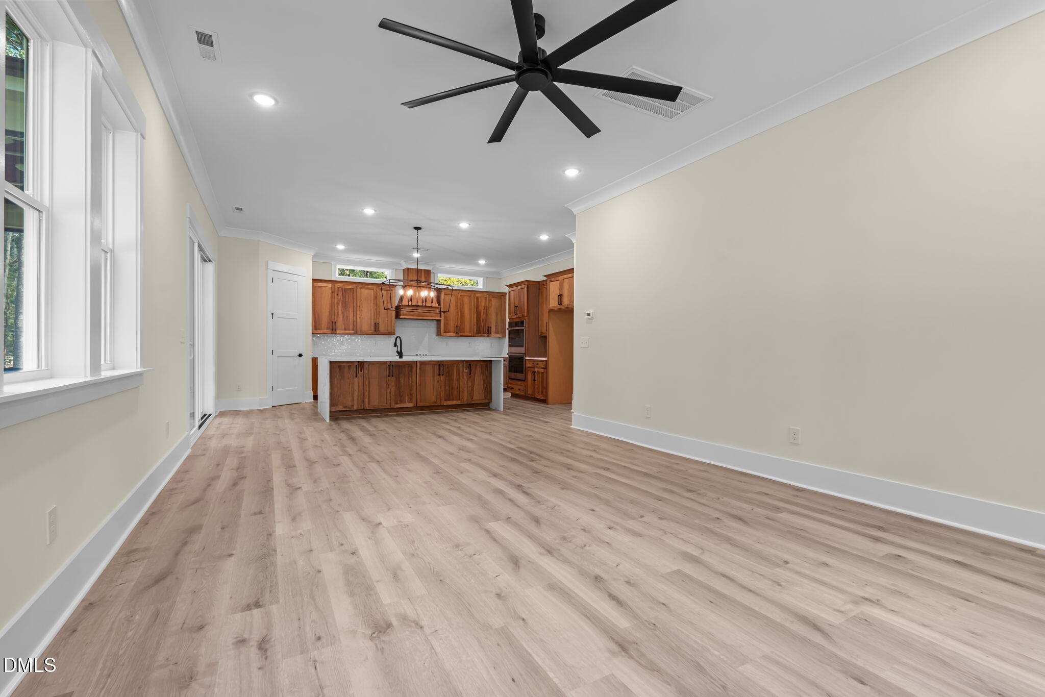 188 Landon Ridge Sanford, NC 27330 - Photo 9 of 44 an empty room with wooden floor and windows
