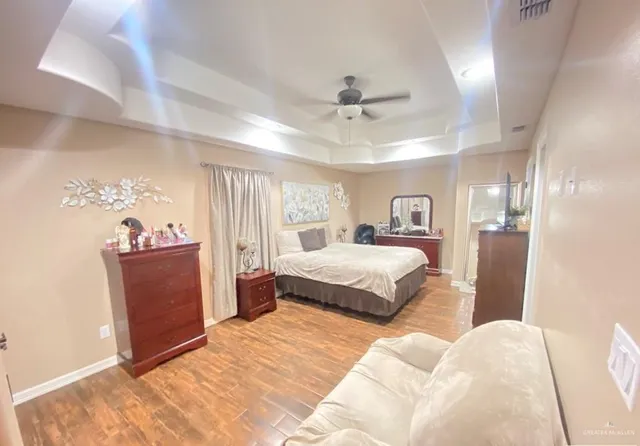 a bedroom with a large bed and a chandelier