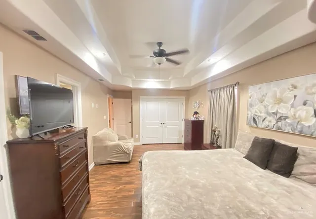 a bedroom with a large bed and a flat screen tv