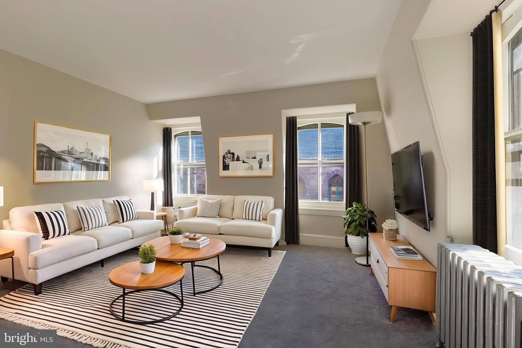 3604 Baring Street, Unit 2 Philadelphia, PA 19104 - Photo 1 of 25 a living room with furniture and a flat screen tv