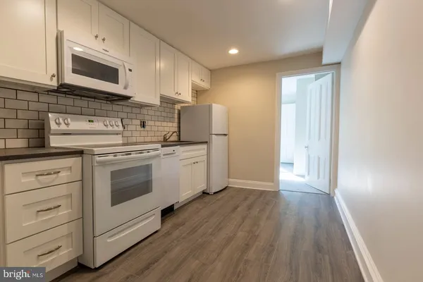a kitchen with stainless steel appliances a white stove top oven and sink
