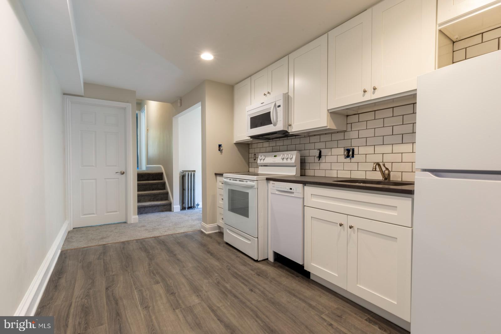 3604 Baring Street, Unit 2 Philadelphia, PA 19104 - Photo 4 of 25 a kitchen with stainless steel appliances white cabinets and a sink