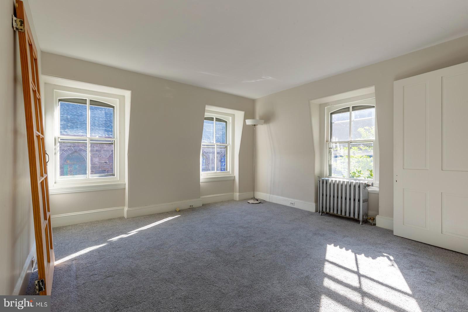 3604 Baring Street, Unit 2 Philadelphia, PA 19104 - Photo 6 of 25 an empty room with windows