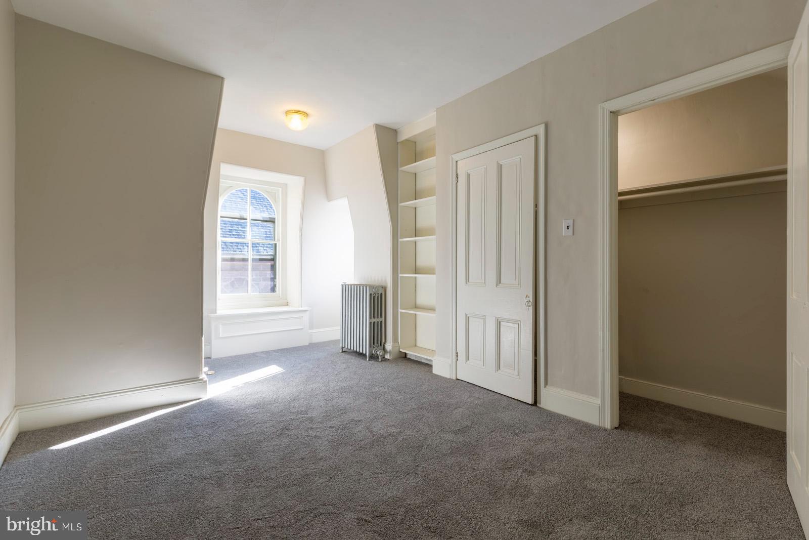 3604 Baring Street, Unit 2 Philadelphia, PA 19104 - Photo 9 of 22 an empty room with closet and a window